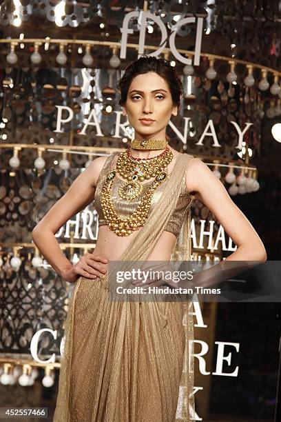 Model walks down the ramp during grand finale by Shree Raj Mahal Jewellers as a part of India Couture Week 2014 at the Taj Palace Hotel on July 20,...