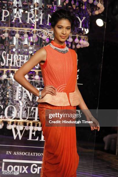 Model walks down the ramp during grand finale by Shree Raj Mahal Jewellers as a part of India Couture Week 2014 at the Taj Palace Hotel on July 20,...