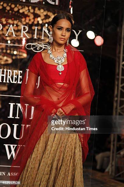 Model walks down the ramp during grand finale by Shree Raj Mahal Jewellers as a part of India Couture Week 2014 at the Taj Palace Hotel on July 20,...