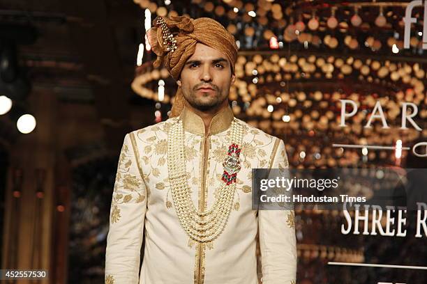 Model walks down the ramp during grand finale by Shree Raj Mahal Jewellers as a part of India Couture Week 2014 at the Taj Palace Hotel on July 20,...