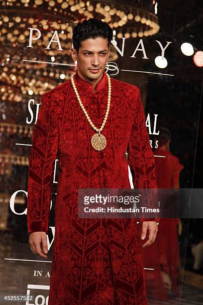 Model-actor Muzammil Ibrahim walks down the ramp during grand finale by Shree Raj Mahal Jewellers as a part of India Couture Week 2014 at the Taj...