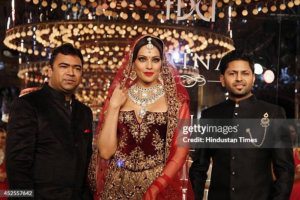 Actresses Bipasha Basu with owners of Shree Raj Mahal Jewellers Praveen Goel and Ashok Goel at the India Couture Week 2014 finale held on July 20,...