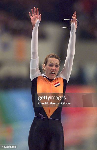 Marianne Timmer, of the Netherlands, raises her hands in victory after finishing the women's 1000-meter speed skating event. She finished in the top...
