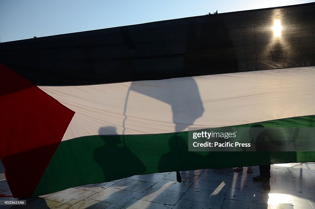 Demonstrators hold a big Palestinian flag. Palestinians that...
