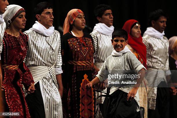 Palestinan children from the Talbeyah camp near Amman, perform traditional Palestinian dance during a a special celebration in solidarity with the...