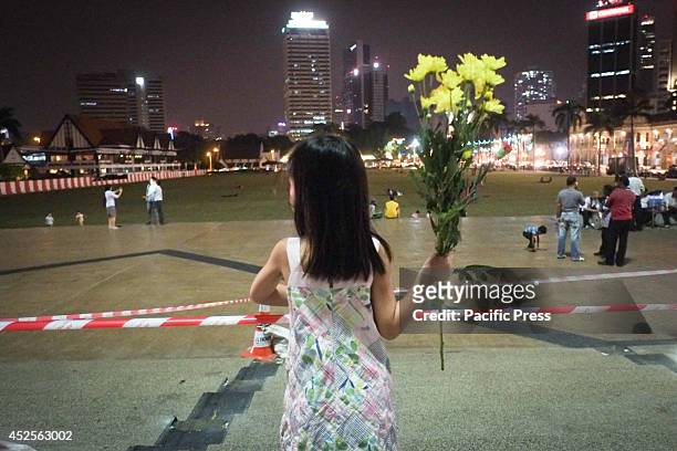 Little girl holds a flower during the vigil for Malaysia Airlines MH-17 victims in Kuala Lumpur, Malaysia. Malaysia Airlines flight MH17 was...