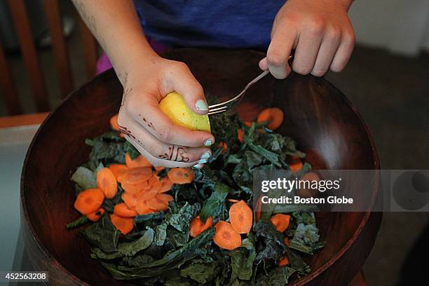 Yonah Kalikow puts lemon juice on her kale slaw. She is a 10-year-old girl from Auburndale, who won the White House Healthy Lunchtime contest. Her...