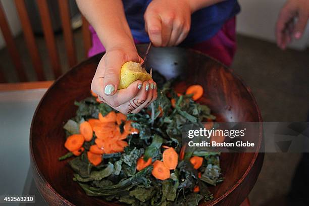 Yonah Kalikow puts lemon juice on her kale slaw. She is a 10-year-old girl from Auburndale, who won the White House Healthy Lunchtime contest. Her...