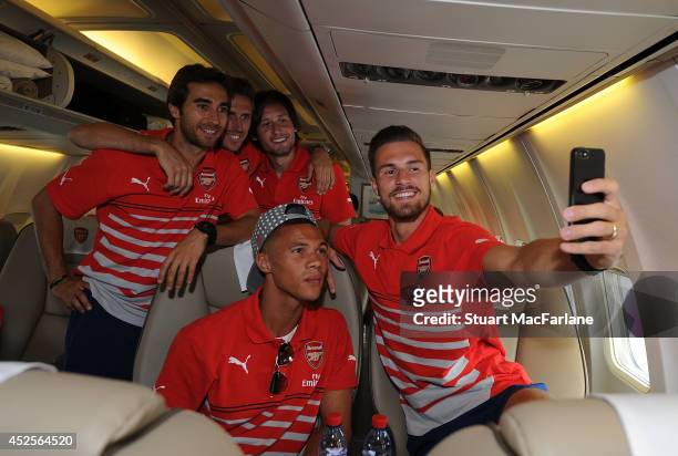 Mathieu Flamini, Nacho Monreal, Tomas Rosicky, Kieran Gibbs and Aaron Ramsey of Arsenal at Luton Airport on July 23, 2014 in Luton, England.