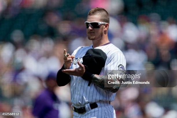 Brandon Barnes of the Colorado Rockies plays paper, rock, scissors with a member of the Washington Nationals during a friendly standoff before the...