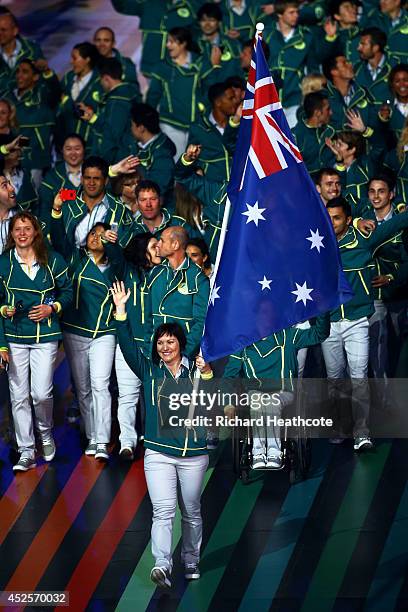 Flag bearer and Cyclist Anna Meares of Australia waves during the Opening Ceremony for the Glasgow 2014 Commonwealth Games at Celtic Park on July 23,...