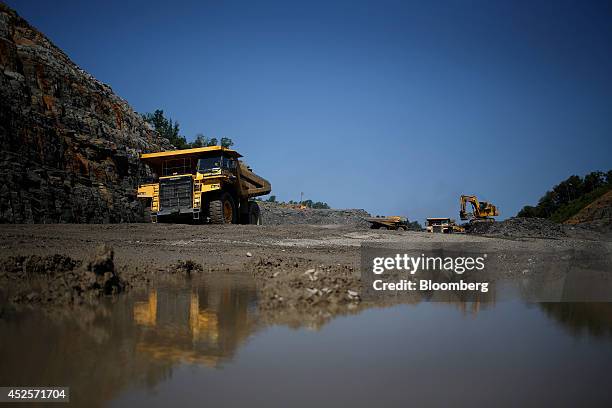 Heavy machinery moves loads of blasted rock during the construction of a new segment of U.S. Highway 460, part of the Appalachian Development Highway...