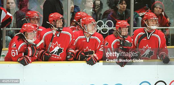 Members of the Canadian women's hockey team look on in the final moments of third period action against the U.S. In women's Olympic gold medal hockey...