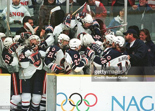 Members of the U.S. Women's hockey team react at the end of their game with Canada. The U.S. Beat Canada 3-1 to take the gold medal in the Olympic...