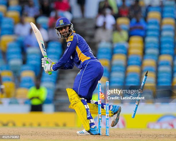 Shoaib Malik of Barbados Tridents is bowled by Tino Best of St. Lucia Zouks during a match between Barbados Tridents and St. Lucia Zouks as part of...