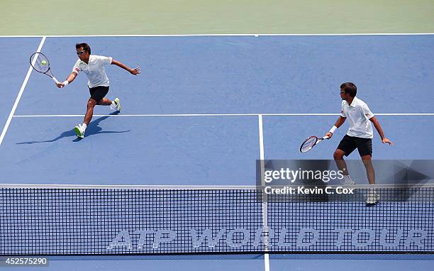 Sanchai and Sonchat Ratiwatana of Thailand return a shot to Victor Estrella Burgos of the Dominican Republic and Nicolas Barrientos of Colombia...