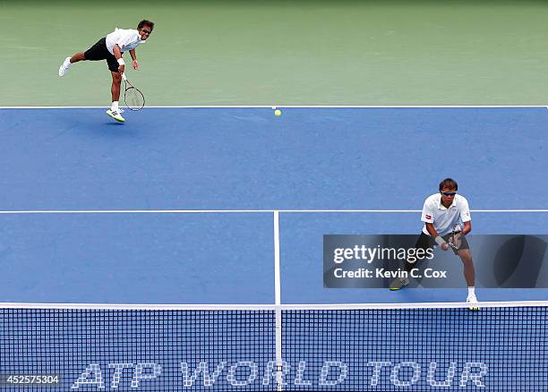 Sanchai and Sonchat Ratiwatana of Thailand serve to Victor Estrella Burgos of the Dominican Republic and Nicolas Barrientos of Colombia during the...