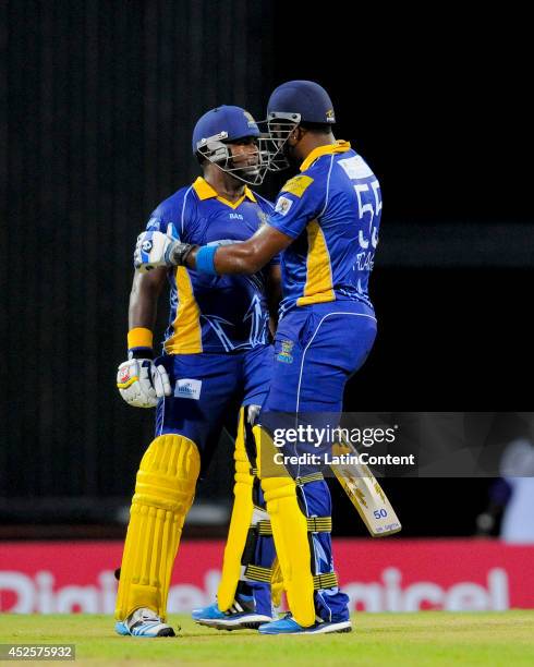 Kieron Pollard congratulates Dwayne Smith of Barbados Tridents for his century during a match between Barbados Tridents and St. Lucia Zouks as part...