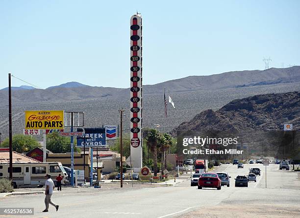 Vehicles drive by a 134-foot-high electronic sign displaying a temperature of 111 degrees Fahrenheit on July 23, 2014 in Baker, California. The...