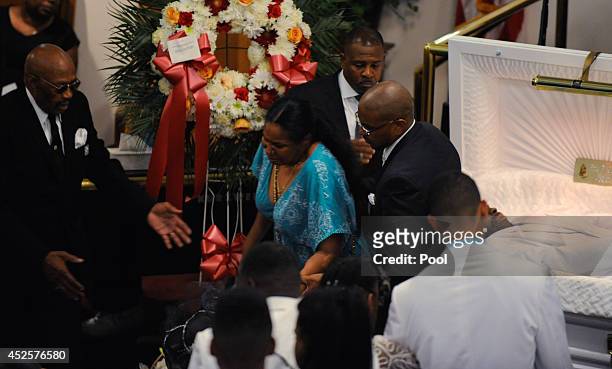 Esaw Garner , wife of Eric Garner, is consoled as she sees her husband for the last time during his funeral service held at Bethel Baptist Church on...