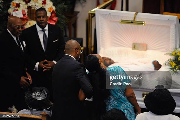 Esaw Garner , wife of Eric Garner, is consoled as she sees her husband for the last time during his funeral service held at Bethel Baptist Church on...