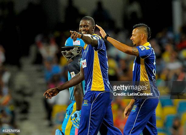 Jason Holder and Rayad Emrit of Barbados Tridents celebrate the dismissal of Henry Davids of St. Lucia Zouks during a match between Barbados Tridents...