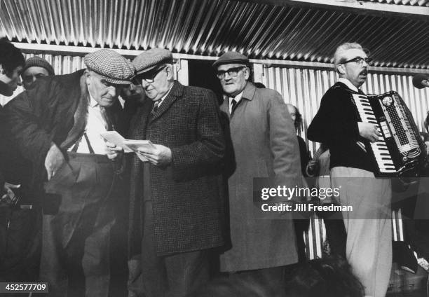 Elderly men exchange notes at the Egremont Crab Fair, Cumberland, September 1974.