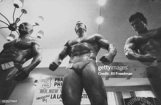 Participants flex their muscles at a body building contest in New York City, 1983.