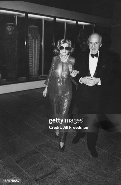 Man accompanies an elderly woman to an event being held at the Metropolitan Museum of Art, New York City, 1983.