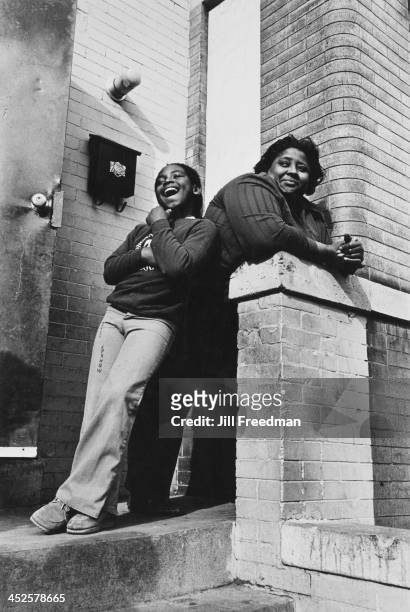 Mother and daughter stand on the steps of an apartment in Washington DC, 1977.