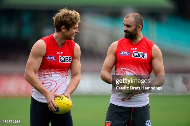 Rhyce Shaw of the Swans speaks with Dane Rampe during a Sydney Swans AFL training session at Sydney Cricket Ground on July 24, 2014 in Sydney,...