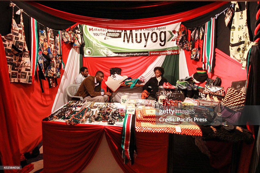 Curators sit at their artwork exhibition stall in Nairobi...