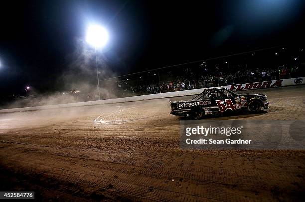 Darrell Wallace Jr. , driver of the ToyotaCare Toyota, does a burnout after winning the Camping World Truck 2nd Annual 1-800 Car Cash Mudsummer...