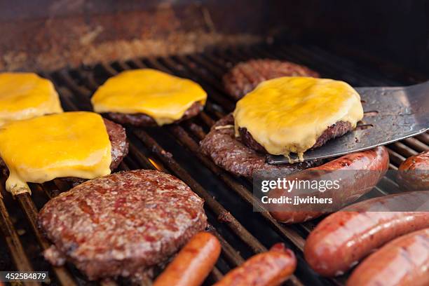 spatula with cheeseburger on grill - hamburger stock pictures, royalty-free photos & images