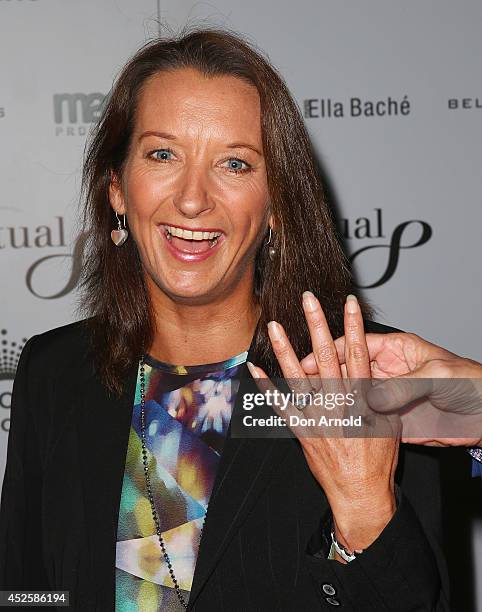 Kirk Pengilly holds Layne Beachley's hand as she shows off her wedding ring during the 'Clarkey For Kids Sports Lunch' at The Ivy on July 24, 2014 in...