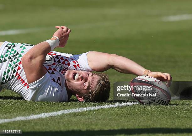 Phil Burgess scores a try during the Dubai Sevens Cup quater final match between Wales and England ,as part of the second round of the HSBC Sevens...