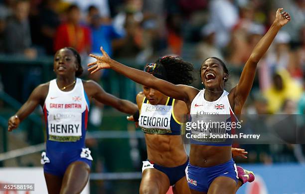 Dina Asher-Smith of Great Britain celebrates her win in the 100m Final against Ángela Tenorio of Ecuador and Desiree Henry of Great Britain during...