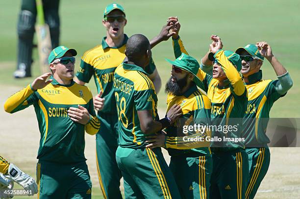 Lonwabo Tsotsobe of South Africa celebrates the wicket of Asad Shafiq of Pakistan with his team-mates during the 3rd One Day International match...