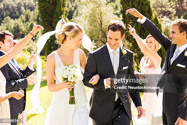 bride and groom procession after wedding - bouquet toss stock pictures, royalty-free photos & images