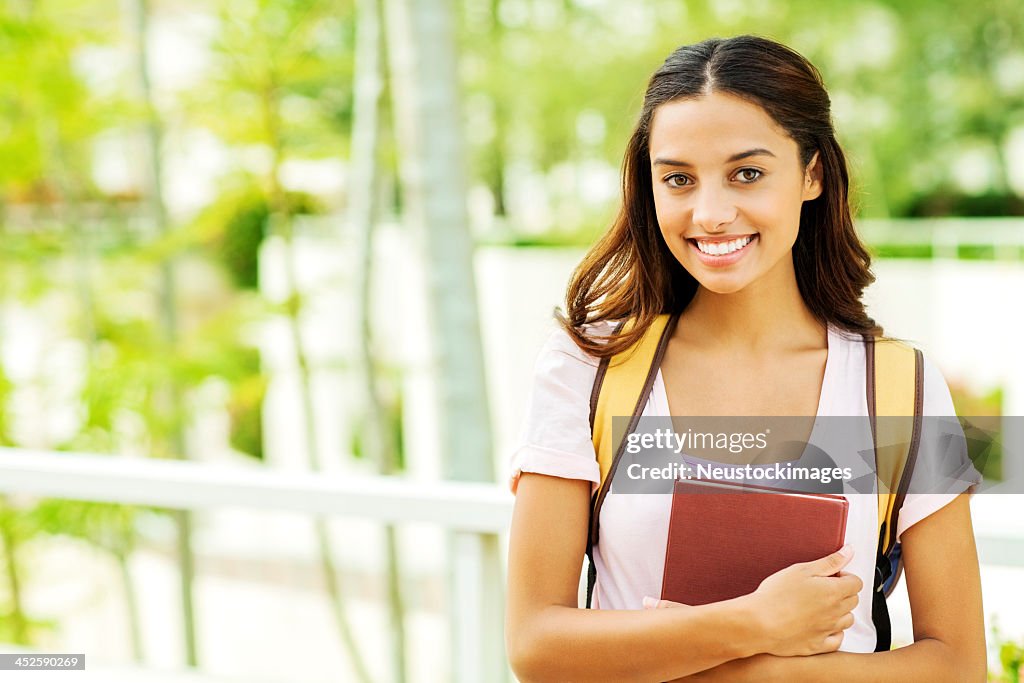 Confident Girl With Book On University Campus