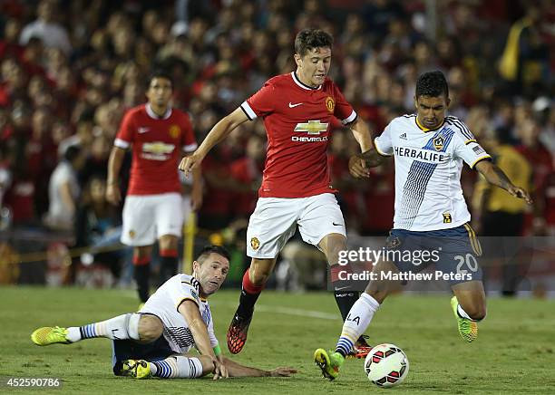 Ander Herrera of Manchester United in action with Robbie Keane and A.J. Delagarza of Los Angeles Galaxy during the pre-season friendly match between...