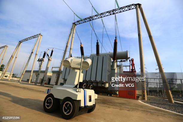 An intelligent patrol robot which looks like "Wall-E" inspects a 220 kv transformer substation at Zhoujia village on July 21, 2014 in Hengyang, Hunan...