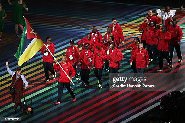 Flag bearer and athlete Kurt Couto of Mozambique leads his team during the Opening Ceremony for the Glasgow 2014 Commonwealth Games at Celtic Park on...