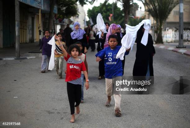 Palestinians flee Khan Yunis to safe areas on July 24 as the Israeli shelling on Gaza within the operation "Protective Edge" killed at least 718...