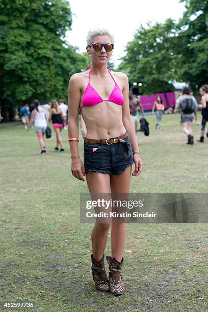 Presenter and Model Danni Menzies wearing Brick Lane market sunglasses, Primark bikini, H and M shorts and Jeffrey Campbell boots at Lovebox 2014 on...