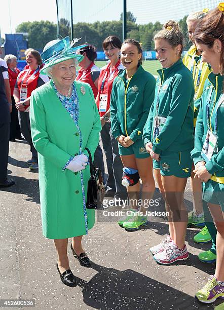 Queen Elizabeth II shares a joke with the Australian Hockey Team as she visits the Glasgow National Hockey Centre to watch the hockey during day one...