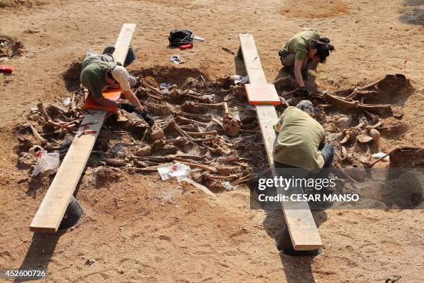 Employees exhume on Mount Estepar near Burgos on July 24 the remains of people dumped in mass graves over the summer of 1936 during the Spanish Civil...