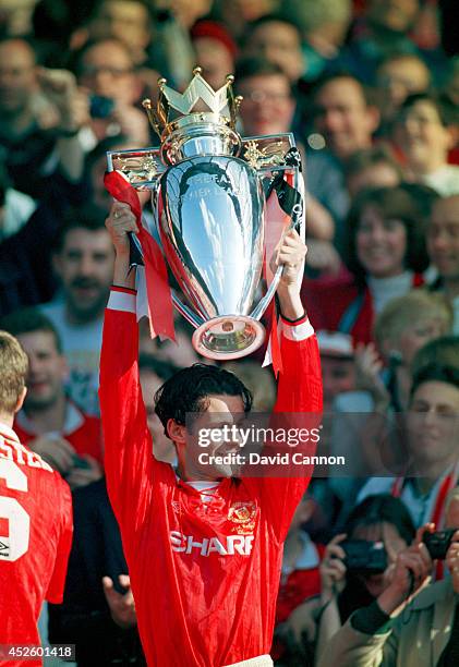 Manchester United forward Ryan Giggs lifts the Premier League trophy after the Premier League match between Manchester United and Coventry at Old...