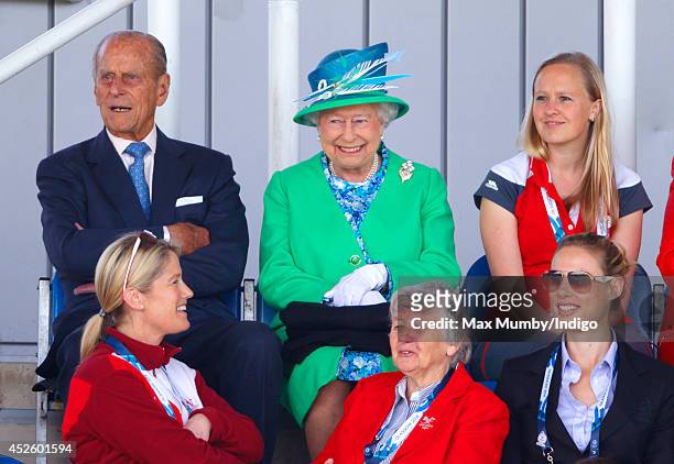 Prince Philip, Duke of Edinburgh and Queen Elizabeth II watch the England vs Wales women's hockey match at the Glasgow National Hockey Centre during...