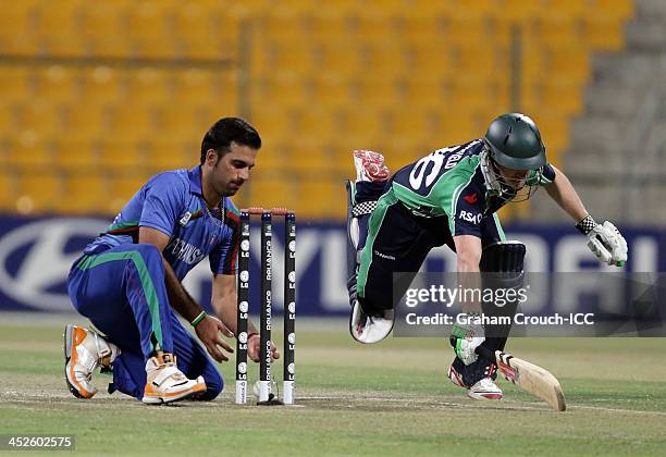 Dawlat Zadran of Afghanistan tries to run out William Porterfield of Ireland during the Ireland v Afghanistan Final at the ICC World Twenty20...